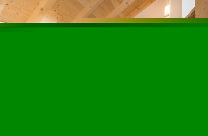 Holzverkleidetes Schlafzimmer mit Doppelbett und Balkonblick.