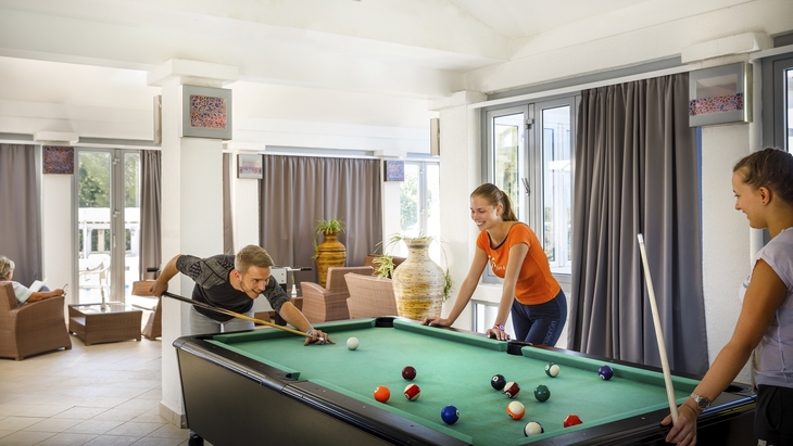 Personen spielen Billard in einem modernen Aufenthaltsraum