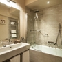 Modernes Badezimmer mit Badewanne, Dusche und Waschbecken.