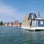 Hausboote auf einem stillen Wasserkanal im Marina Azzurra Resort in Lignano.