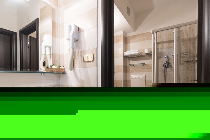 Badezimmer mit Waschbecken, Dusche und WC in einer Ferienwohnung.