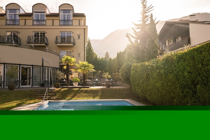 Außenansicht der Villa Laurus mit Pool und Terrasse bei Sonnenschein.
