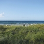 Düne mit Gras vor einem Strand und der Ostsee in Kühlungsborn.
