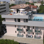 Hotel Olimpia in Bibione mit Pool auf der Dachterrasse und umgeben von Gebäuden.