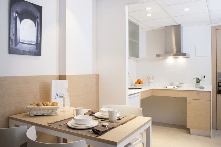 Helle Küche und Essbereich in einem Aparthotel mit modernem Design.