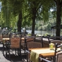 Außenterrasse des Karlstadt Hotels mit Blick auf den Fluss und Bäume im Hintergrund.
