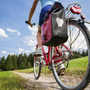 Radfahrer auf einem Feldweg am Chiemsee mit Blick auf Berge im Hintergrund