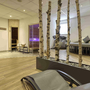 Wellnessbereich im Hotel mit Liegen und Sauna, umgeben von Birkenstämmen.