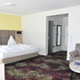 Doppelzimmer im Bellevue Hotel mit modernem Interieur und buntem Teppich.