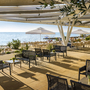 Terrasse mit Meerblick, Sitzbereich, Sonnenschirme und Pflanzen im Resort.
