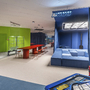 Bunt gestalteter Kinderspielraum mit Tisch und Sitzgelegenheiten im Hotel.