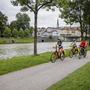 Radfahrer an der Isar in Bad Tölz auf Radweg unter Bäumen.