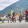 Radfahrer am Tegernsee mit Bergen im Hintergrund