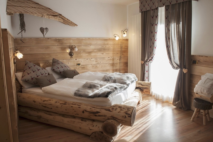 Gemütliches Schlafzimmer in rustikalem Stil mit Holzdekor und Doppelbett.
