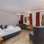 Komfortables Doppelzimmer mit Bett, Schreibtisch und Balkonblick.