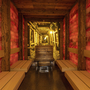 Holzsauna mit roten Salzwänden und Bänken im Spa & Wellness-Bereich.
